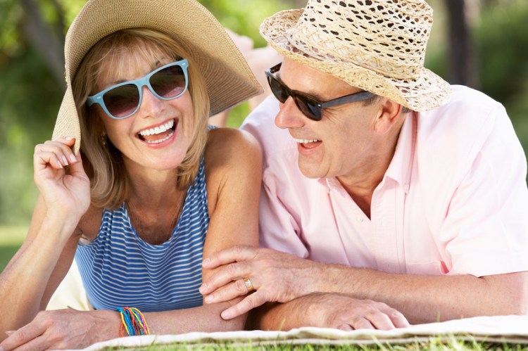 Senior Couple Relaxing In Summer Garden